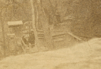 A closer look at this picture shows a photographer's business: a platform to pose people in front of the falls, and a dark room to develop their pictures.