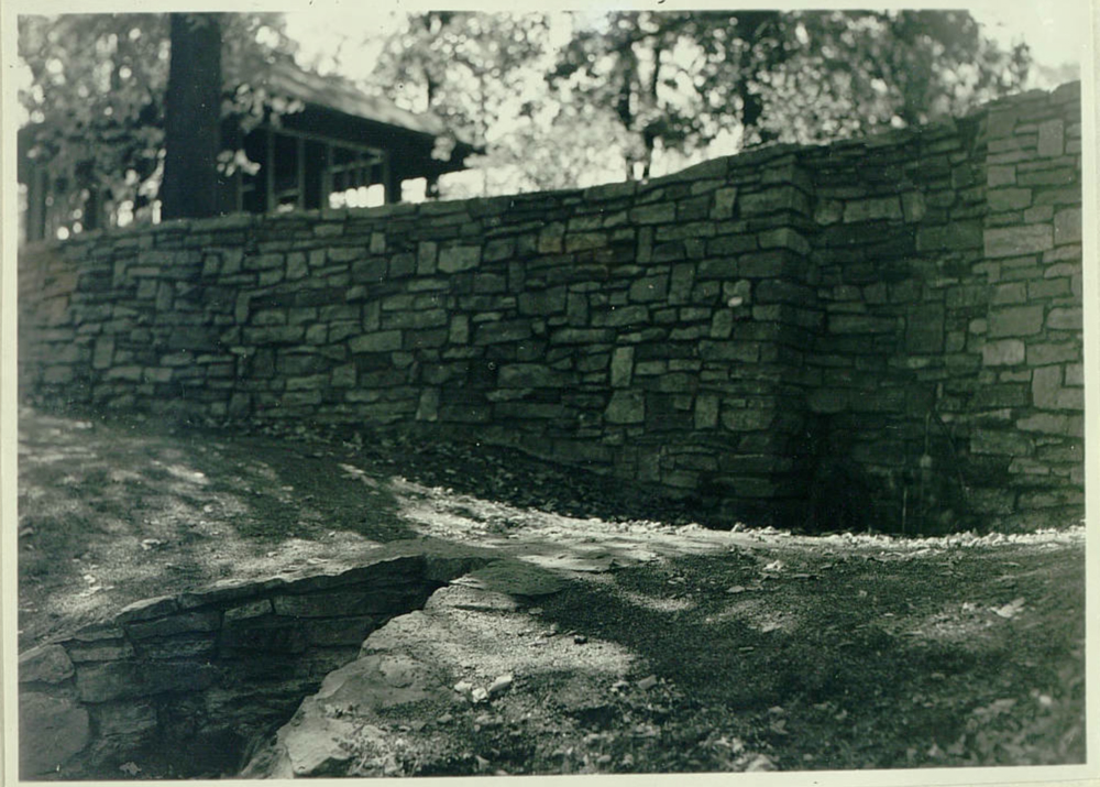 conduit for water under a retaining wall