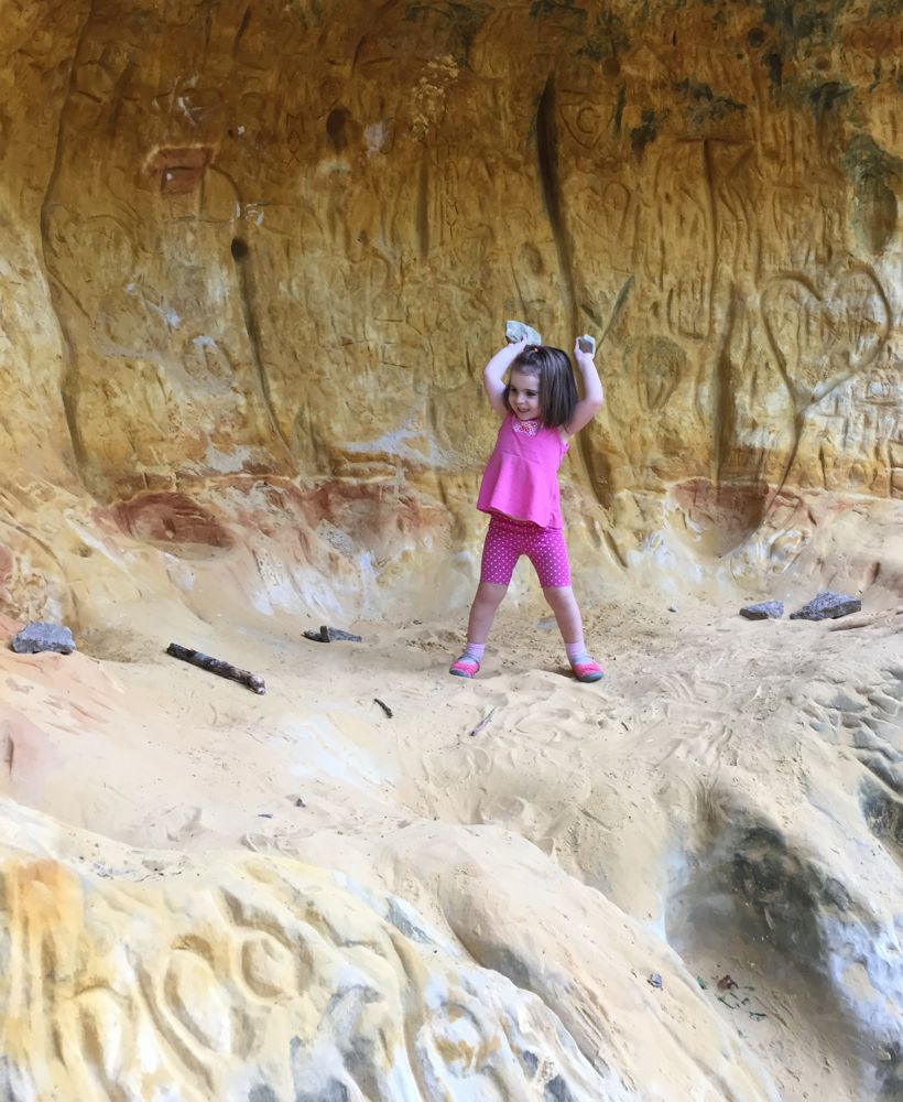 modern Sugar Cave. A child stands in the colorful sand "cave"